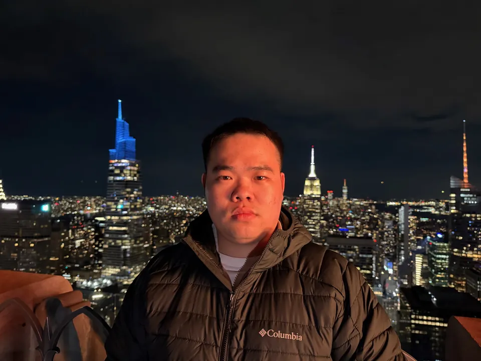 Jinhao above the lit Manhattan skyline at night