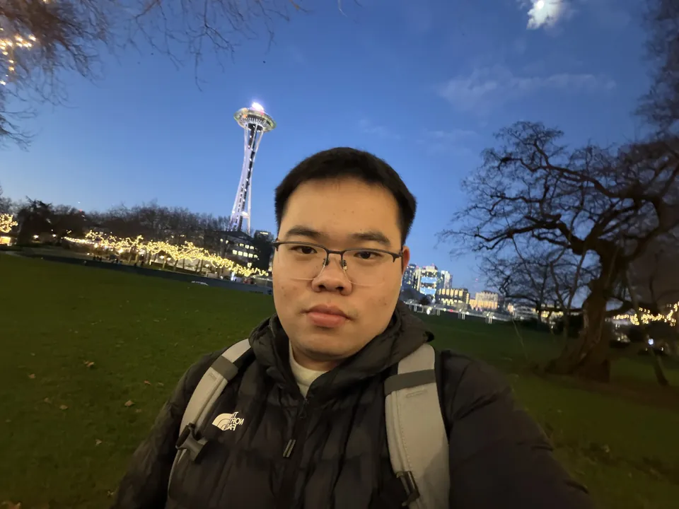 Jinhao at dusk on a lawn with the lit Space Needle behind