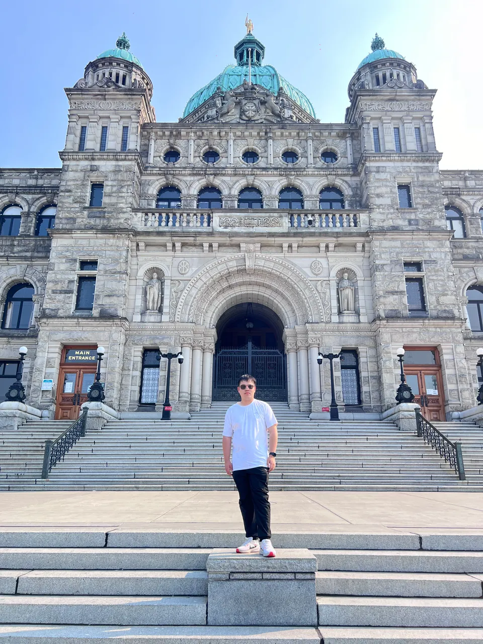 Jinhao on the steps in front of the stone Parliament Buildings